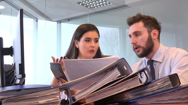 Accountants bookkeeping office man woman with pocket calculator paperwork files