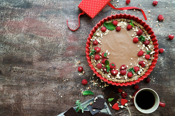 Raw vegan chocolate tart decorated with berries. Concept of healthy dessert
