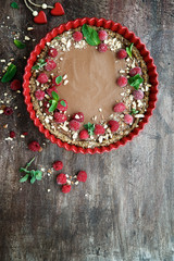 Raw vegan chocolate tart decorated with berries. Concept of healthy dessert
