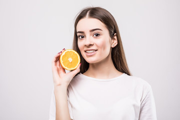 portrait of attractive caucasian smiling woman with orange isolated on white background. Health concept.