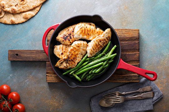 Grilled chicken with green beans in a skillet