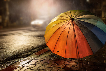 Umbrella,hard rain fall at night  ,selective focus and color toned.