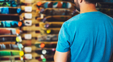 Assortment skateboard isolated in store shop, person choosing and buy color skates on backgraund sun flare, healthy and activity lifestyle concept close up, man consider sport board for driving