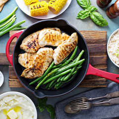 Grilled chicken with green beans in a skillet