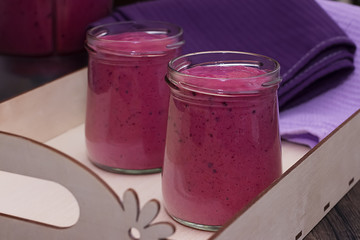 Berry smoothies in glass bowls.