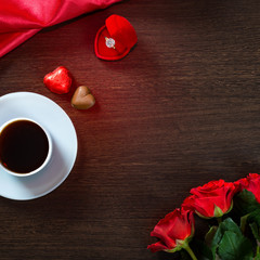 Happy Valentines Day romantic background with wedding ring, rose flowers, cup of coffee and chocolate candy