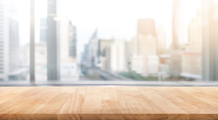 Empty wood table with blur room office and window city view background.For montage product display or design key visual