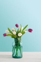 Bright tulips bouquet closeup on blue background