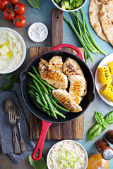 Grilled chicken with green beans in a skillet