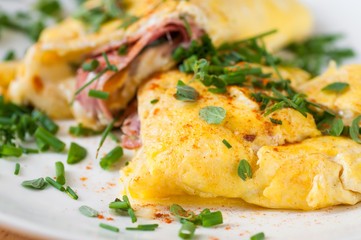 Fluffy egg omelette with ham and cheese, chive.