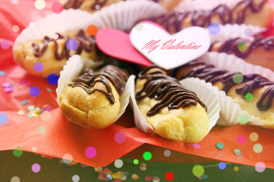 valentine's day concept, holiday greeting card - sweet love, breakfast for lover: eclairs and hearts on red festive background with greeting: my valentine
