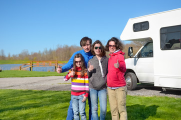 Family vacation, RV travel with kids, happy parents with children have fun on holiday trip in motorhome, camper exterior
