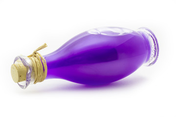 Bottle with purple oil on a white background