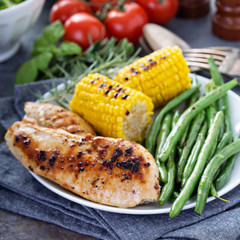 Grilled chicken with green beans in a skillet