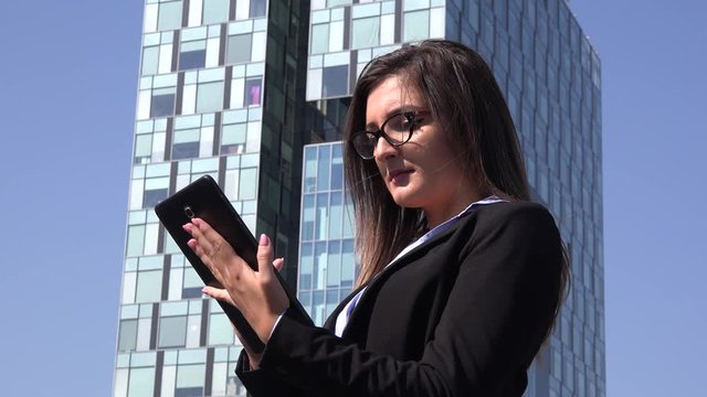 Business woman in the city outdoors working remote on tablet executive strategy