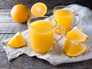 Fresh orange juice on wooden background, rustic style