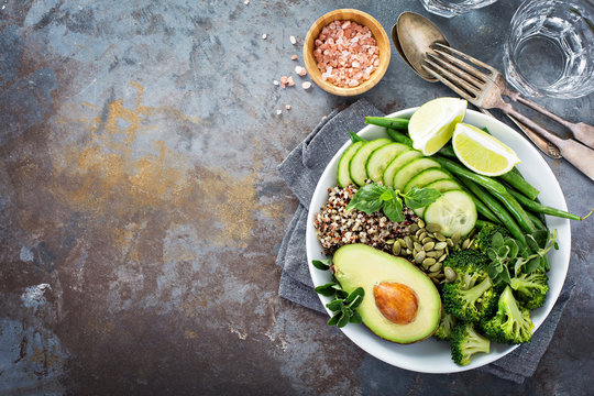 Green vegan lunch bowl with quinoa and avocado
