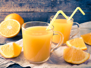 Fresh orange juice on wooden background, rustic style