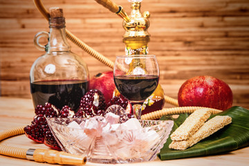 Still-life with Hookah, wine, garnet and sweets