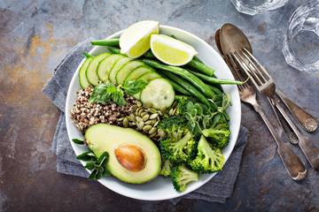 Green vegan lunch bowl with quinoa and avocado