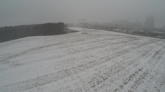 Power lines in the snow. Cogeneration plant in a strong blizzard