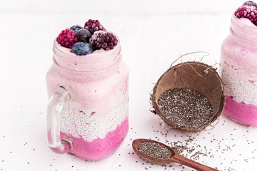 chia with yoghurt, frozen bananas and wild berries, on a white background