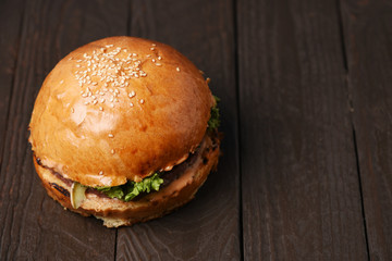 American burger on wood table with copy space overhead