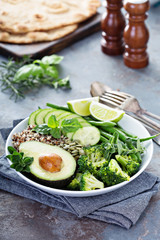 Green vegan lunch bowl with quinoa and avocado