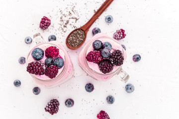 chia with yoghurt, frozen bananas and wild berries, on a white background