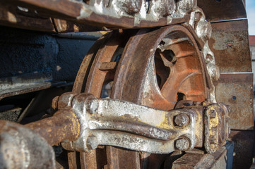 Closeup and Selective Focus Rusty Wheel of Earth Mover Caterpillar Track.