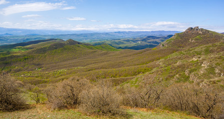 Mountains and hills with trees against blue sky. Georgia.