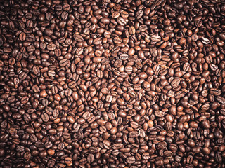 Background of  roasted coffee grains Food backdrop macro close-up