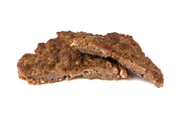 Fried cutlet isolated on white background. Fried beef cutlet for burger cut into two pieces.