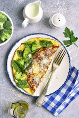 Omelette stuffed with broccoli, cheese and chard leaves for a breakfast.Top view.