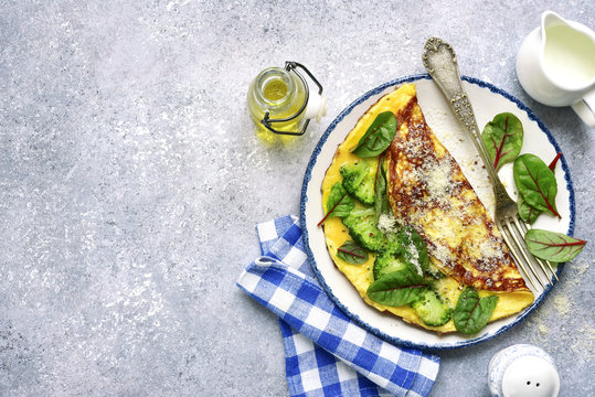 Omelette stuffed with broccoli, cheese and chard leaves for a breakfast.Top view.