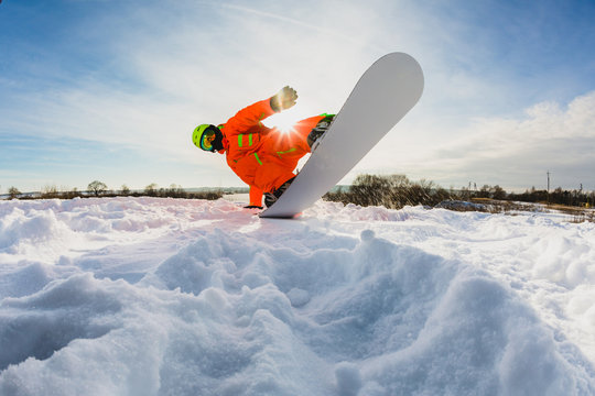 Snowboarder doing a trick on the ski slope