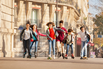 Teenagers rollerblading along the city streets
