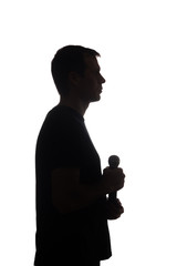 Young man with microphone in his hands - silhouette
