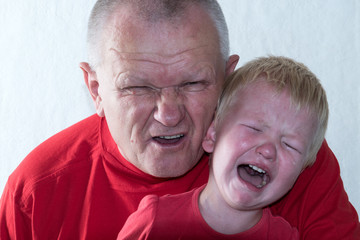 Caucasian boy playing with his elderly father.