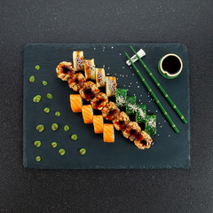 Sushi Set nigiri and sushi rolls on gray stone slate on metal background