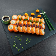 Sushi Set nigiri and sushi rolls on gray stone slate on metal background