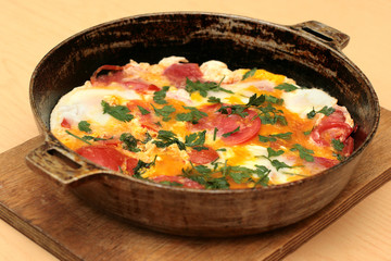 fried eggs on a frying pan, delicious fried eggs with tomatoes