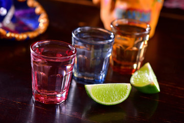 Tequila shoots on dark background