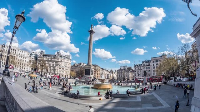 Time lapse fish eye view of Trafalgar square in London with fountains, admiral Nelson column, car traffic and people