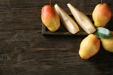 Delicious ripe pears on wooden background, top view