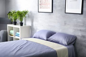 Cozy room interior with comfortable bed, closeup