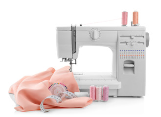 Modern sewing machine with threads and fabric on white background
