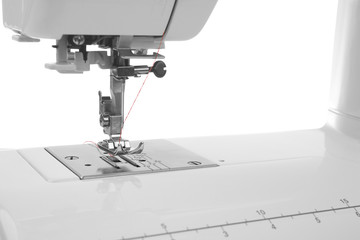 Modern sewing machine with thread, closeup