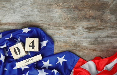 Block calendar and American flag on wooden background. Independence day celebration