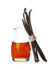 Bottle with vanilla extract and sticks on white background